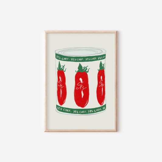a framed print of three red peppers in a jar