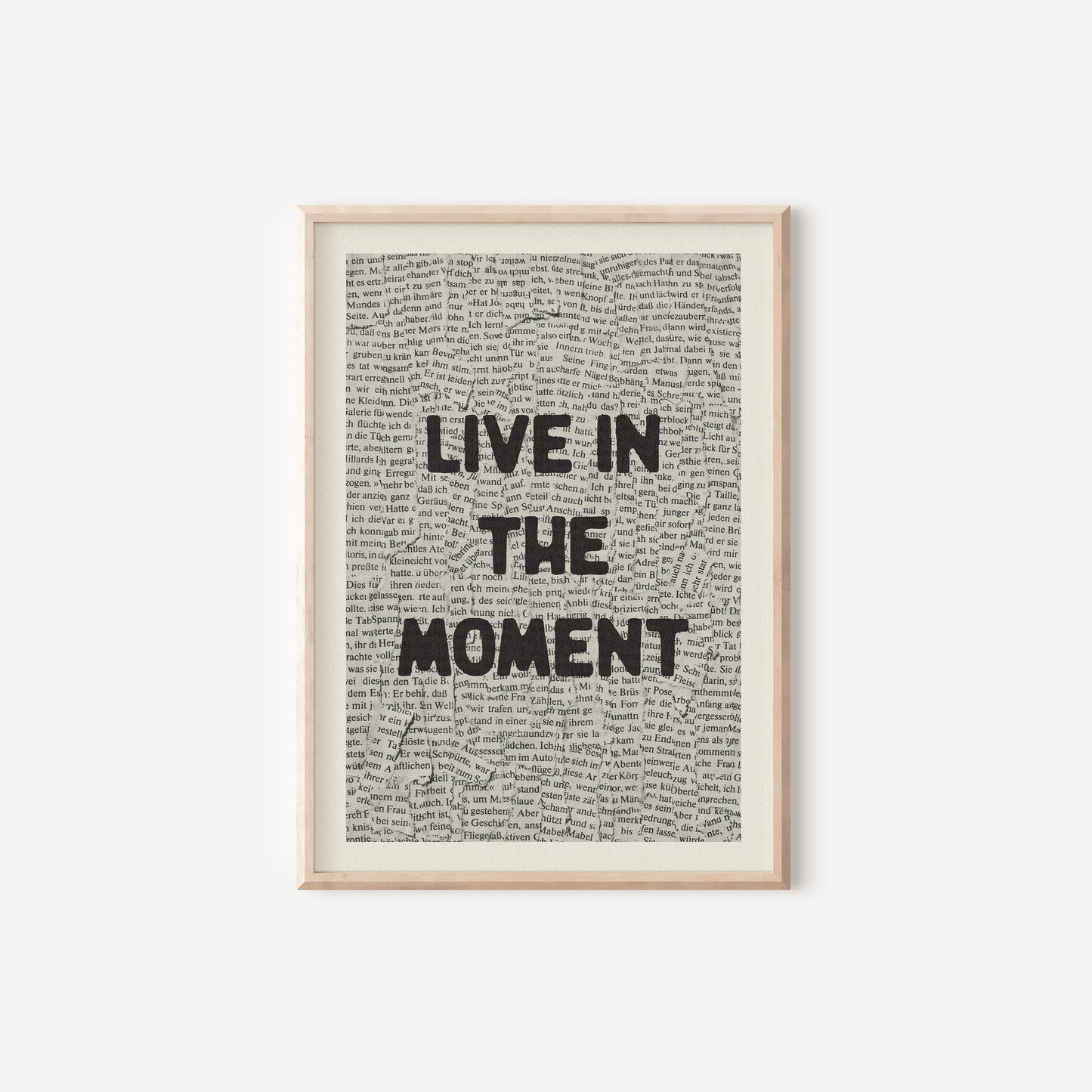 a framed print with the words live in the moment