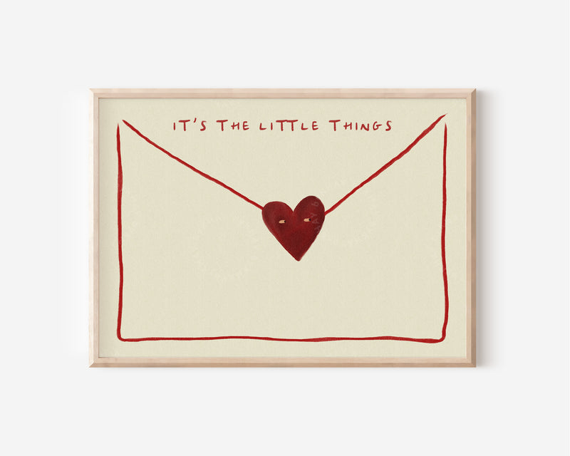 The image is a framed print with a heart-shaped symbol and the text "IT'S THE LITTLE THINGS" written above it.