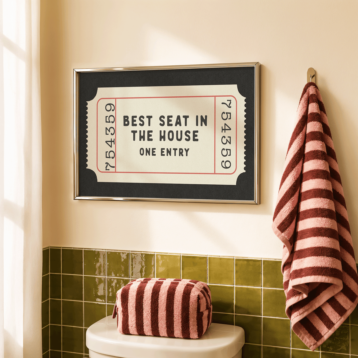 a framed sign that reads "BEST SEAT IN THE HOUSE ONE ENTRY" in a bathroom setting.