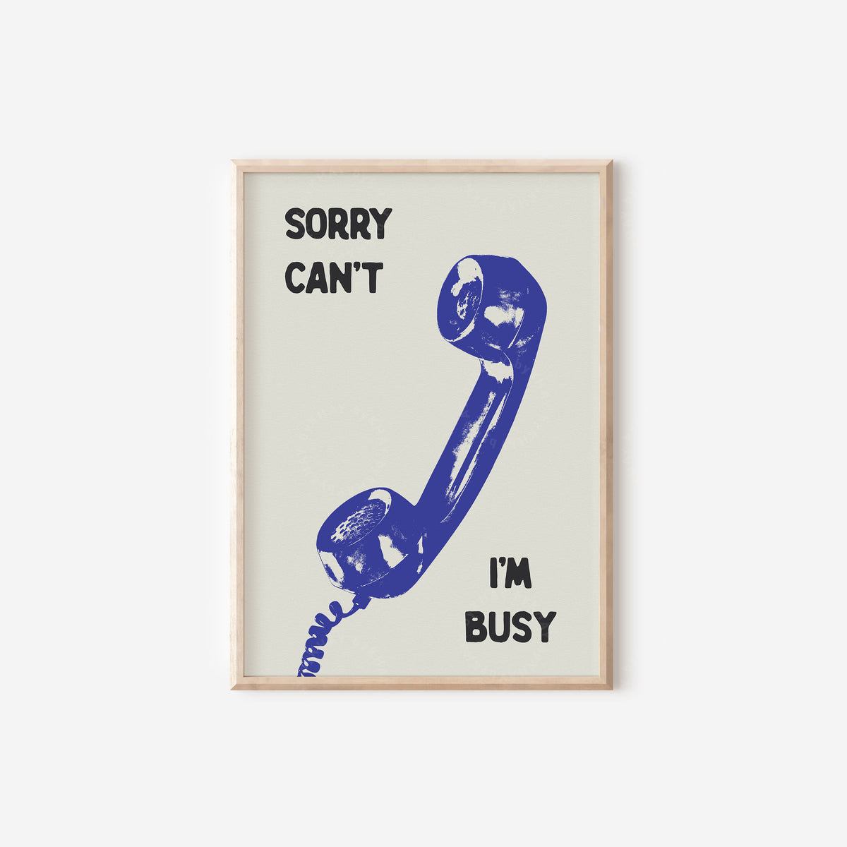 a framed poster with a blue telephone and the text "Sorry can't I'm busy".